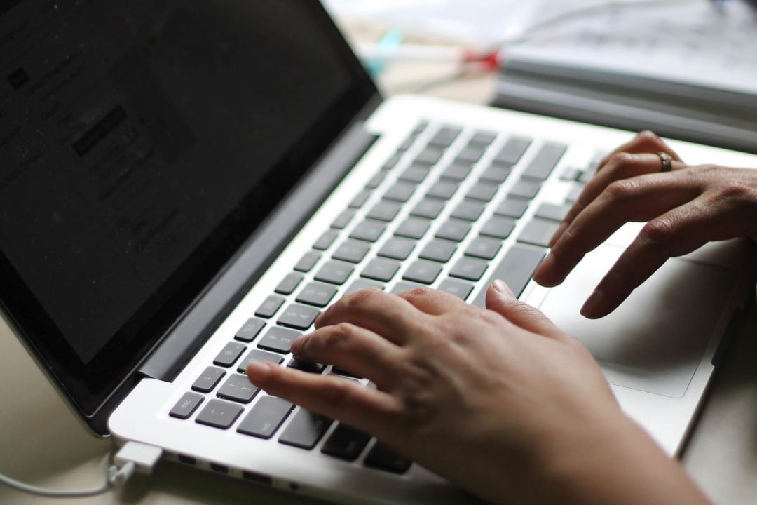 Person typing on laptop